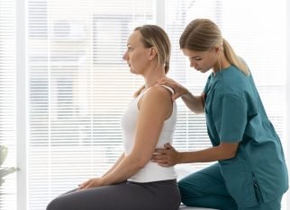 young-physiotherapist-helping-patient-with-back-problems